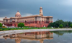 The Secretariat Building in New Delhi, comprising the North and South Blocks, houses key ministries of the Indian government, including the Prime Minister’s Office and the Ministry of Finance. Designed by Sir Herbert Baker and completed in 1931, the twin structures exemplify Lutyens-era colonial architecture with red and cream sandstone facades, domes, and colonnades. Standing atop Raisina Hill facing Rashtrapati Bhavan, the buildings symbolize India’s administrative power and the enduring legacy of New Delhi’s early 20th-century design.